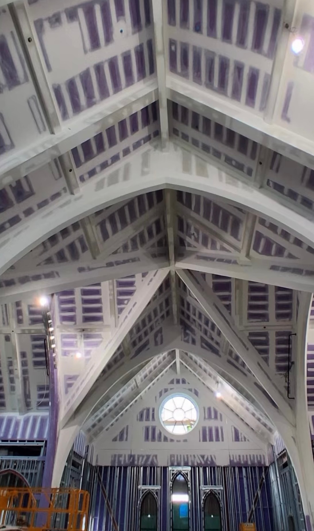 Finished and taped drywall ceiling with vaulted trusses in a large interior